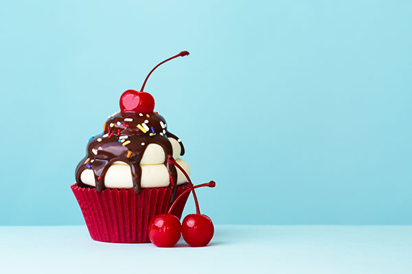 cup cake with cream chocolate and a cherry on the top