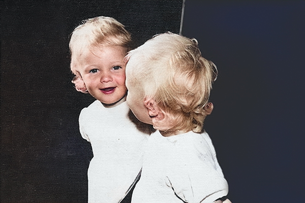 A Child Smiling At Their Reflection