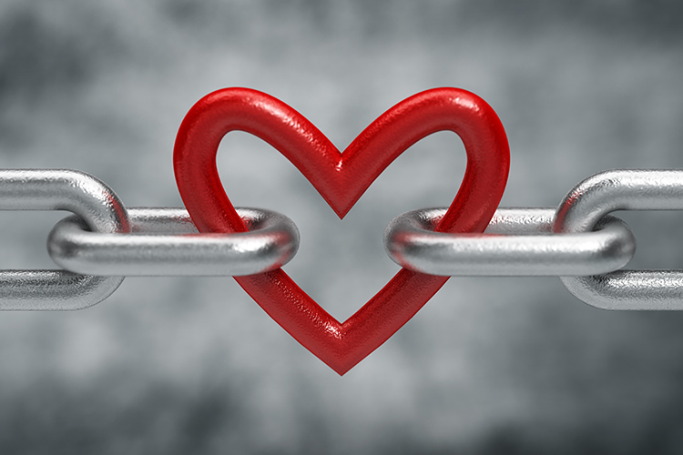 A Red Heart Linking Two Metal Chains